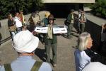 Ranger Sara Daleiden holds scenic view markers, pointing out a nearby high-speed trail and historic downtown.
