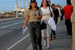 Ranger Cathy leads hikers across the 1st St Bridge to view the infrastructure of forgetting.